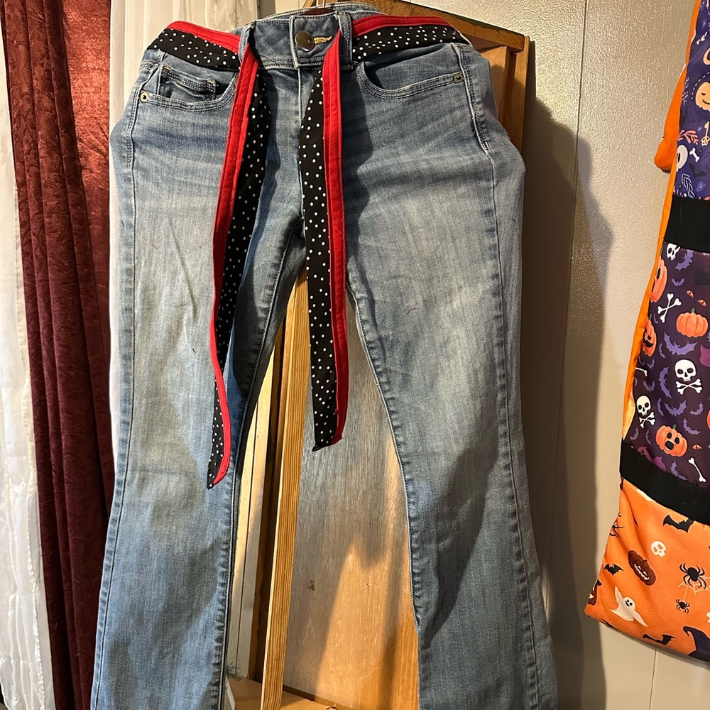 Stylish Blue Jeans with Red and Black Polka Dot Belt